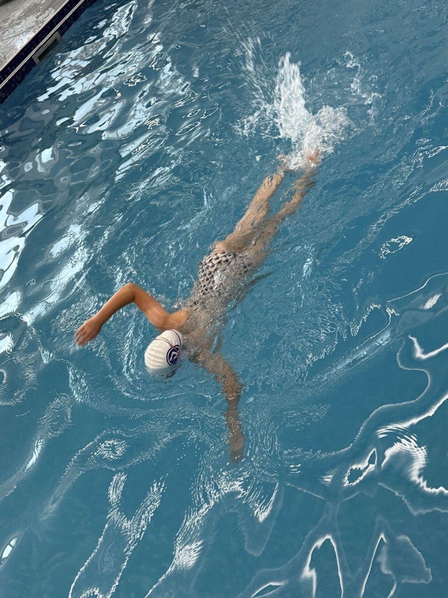 Advanced swimmer doing front crawl wearing Strokes swim cap