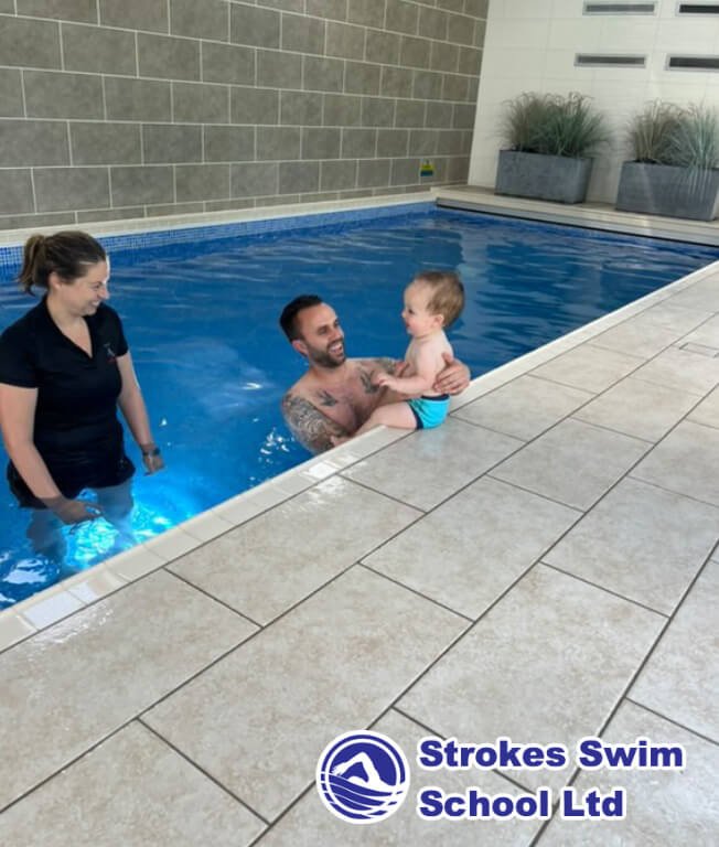 Dad with baby poolside at boutique swimming lesson