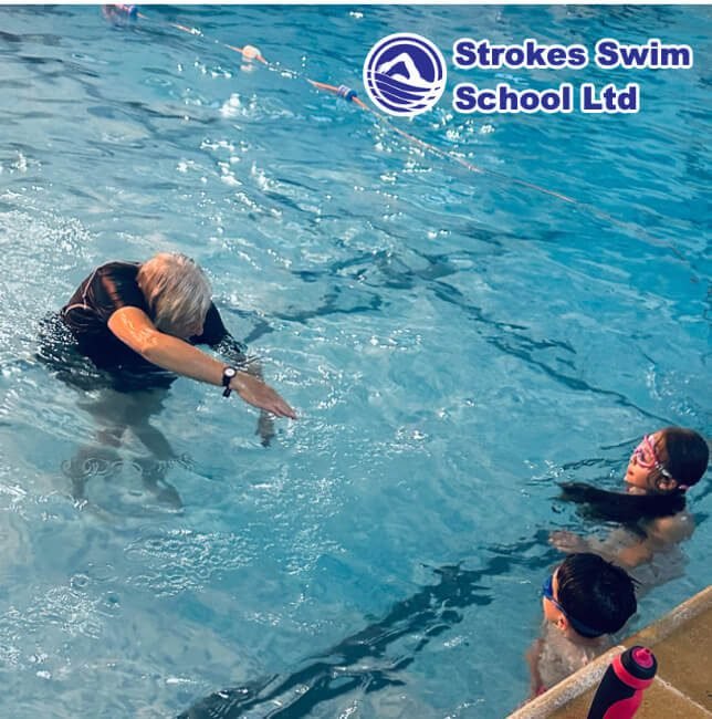 Instructor teaching at school swimming pool