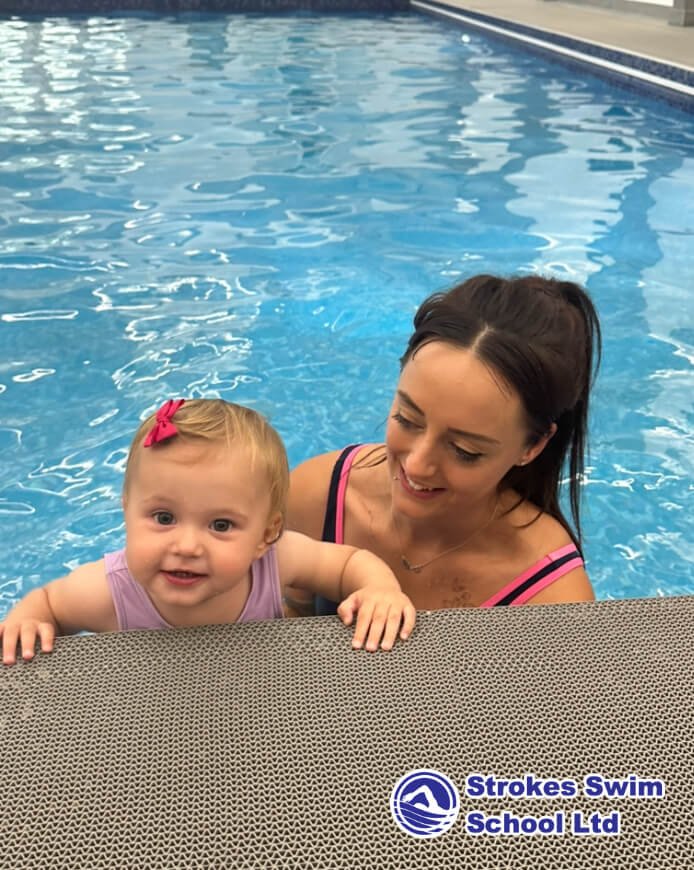 Mum and baby at swimming class poolside