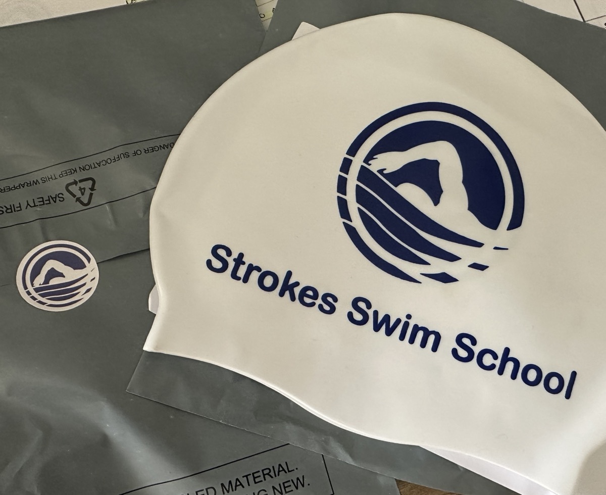 Strokes Swim School branded swimming cap