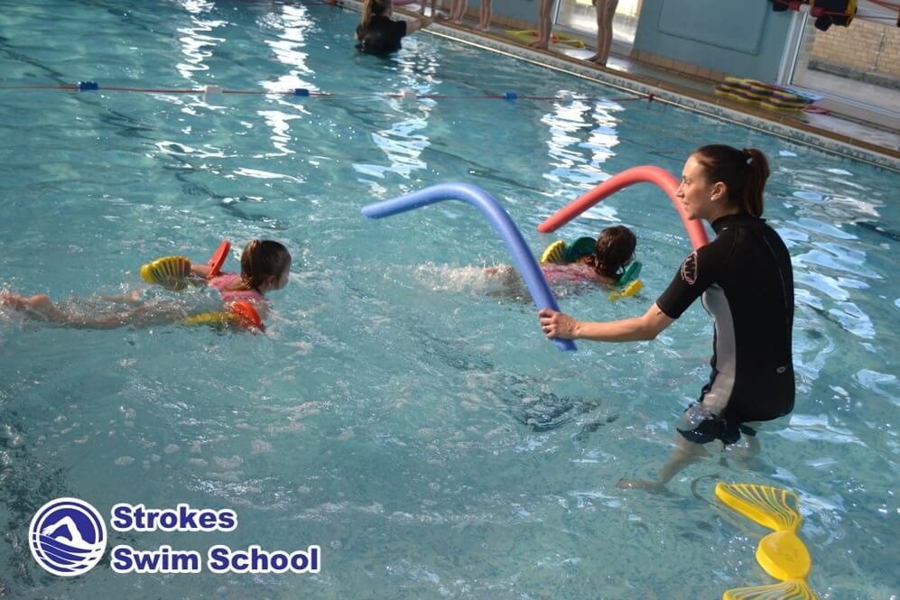 Swimming lesson in progress at a Strokes Swim School pool